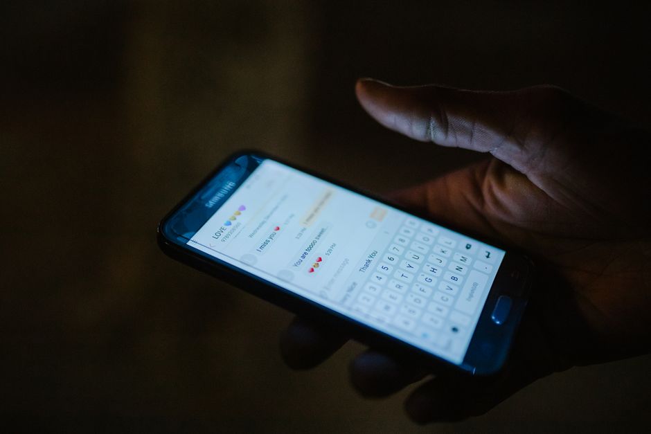 smartphone showing a group chat app - Swinger party invites